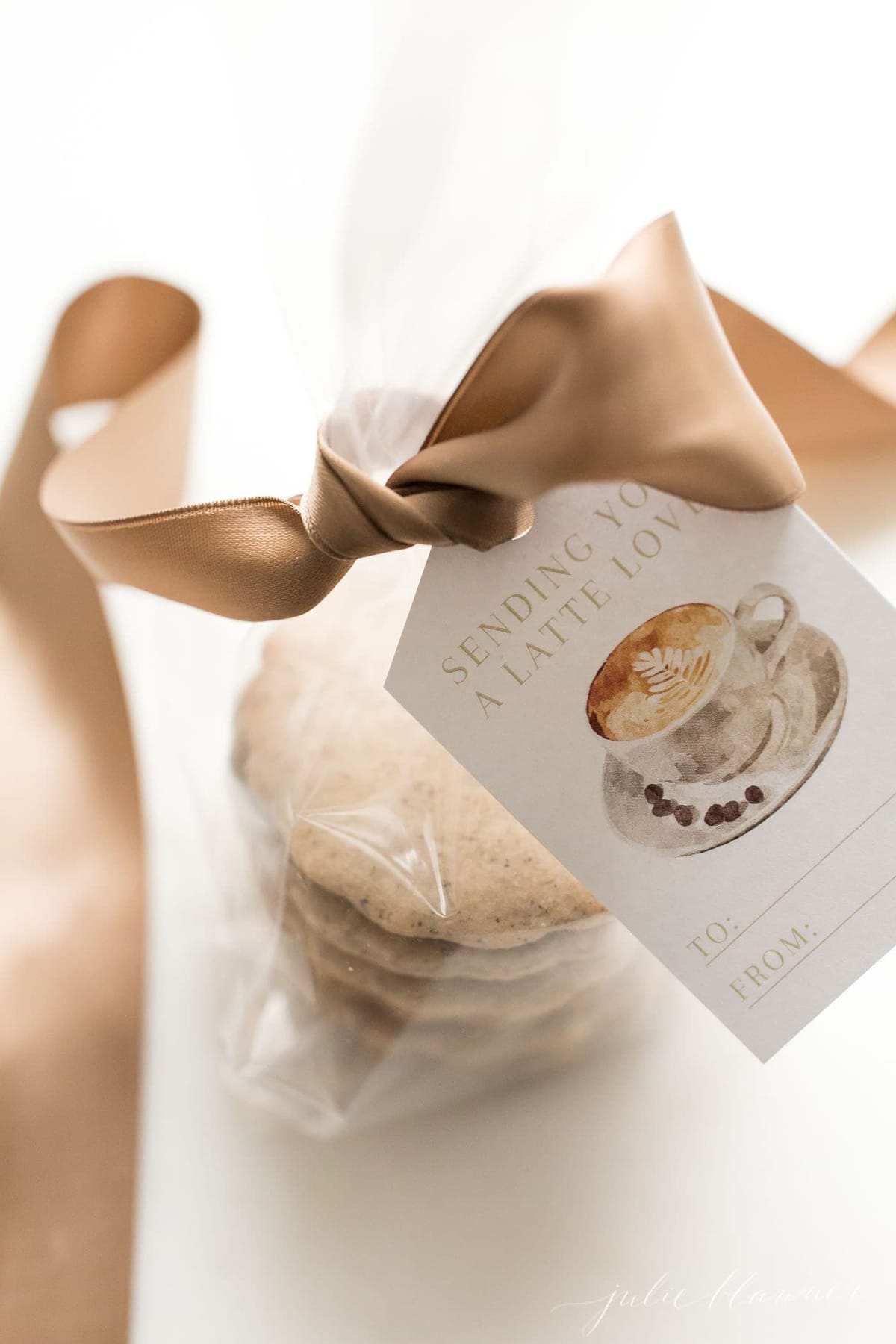 espresso cookies in a cello wrapped stack, tied with a brown satin bow and gift tag that reads 