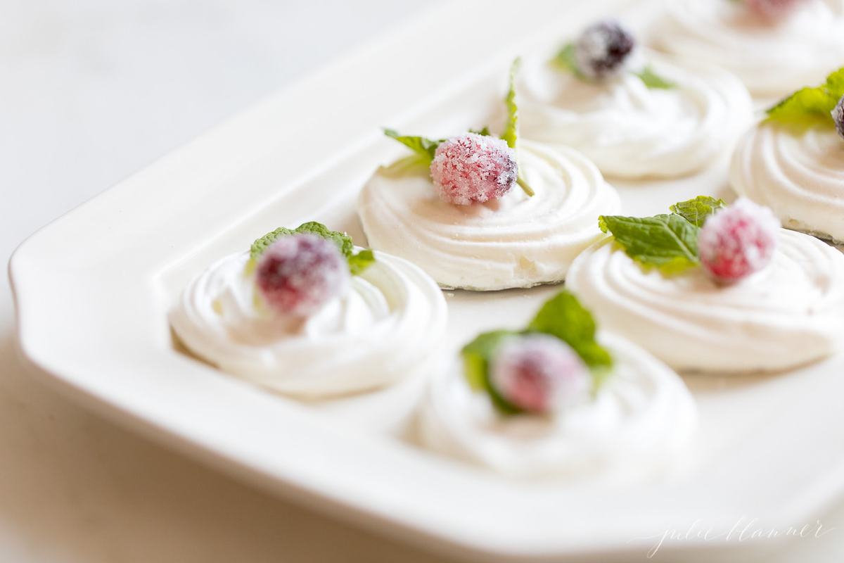 Christmas meringue cookies decorated on a white plate