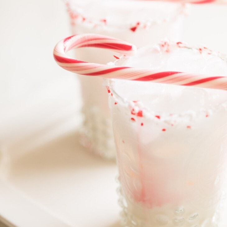cocktail with peppermint schnapps garnished with candy cane