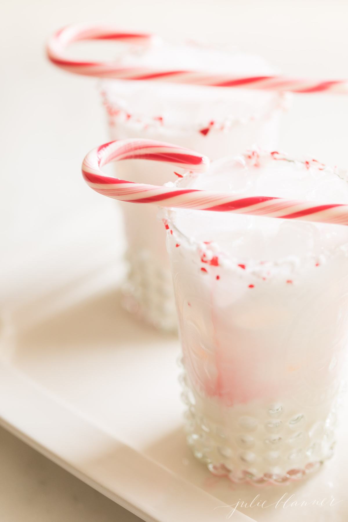 cocktail with peppermint schnapps garnished with candy cane