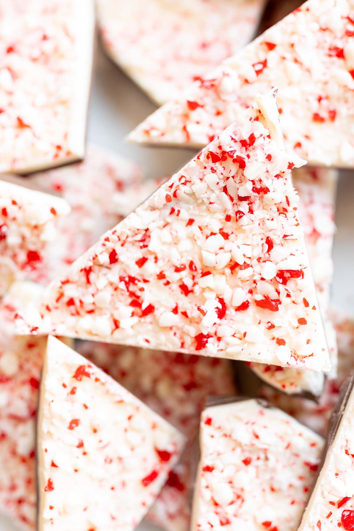 Chunks of salted peppermint bark on a white serving platter.