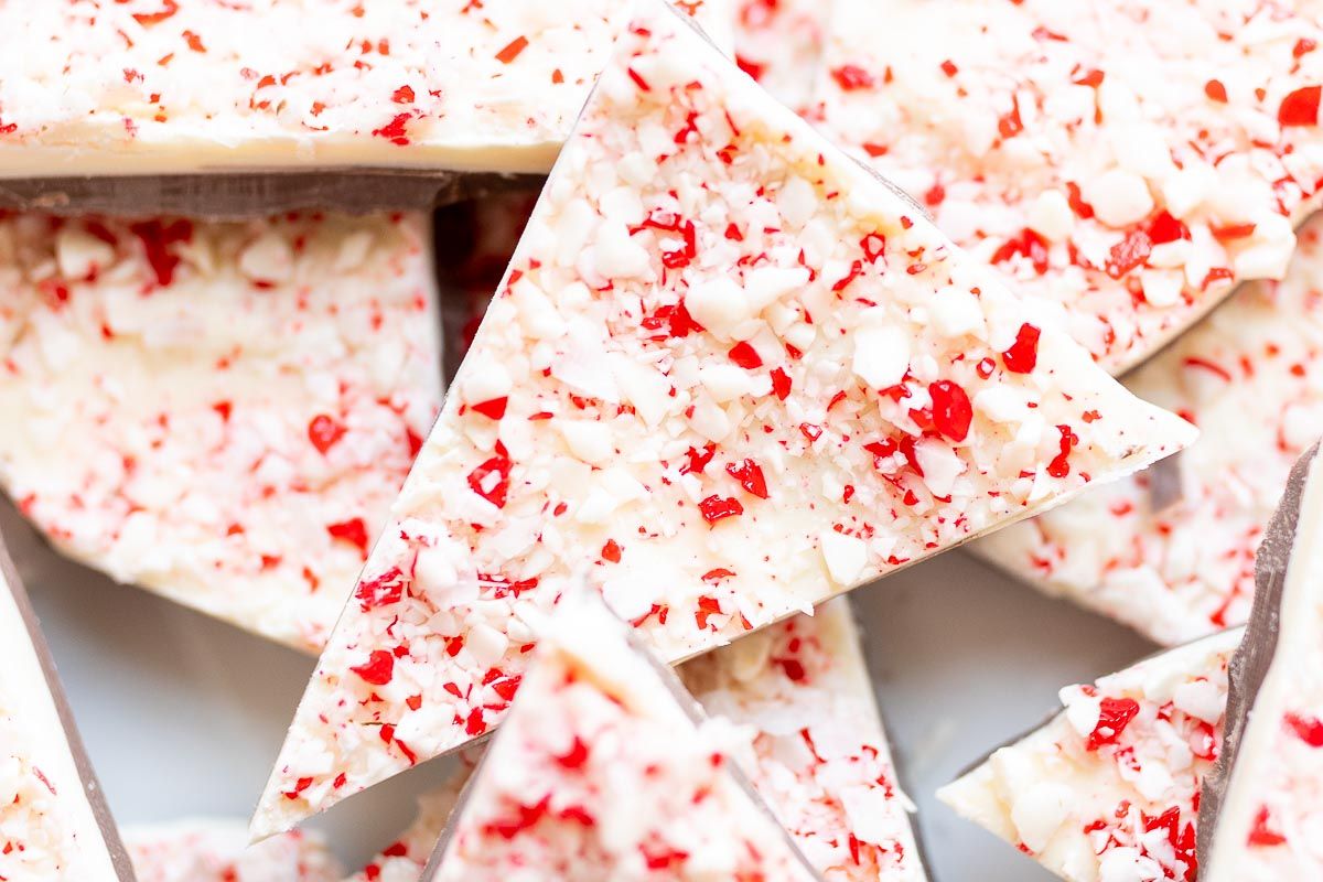 Chunks of salted peppermint bark on a white serving platter.