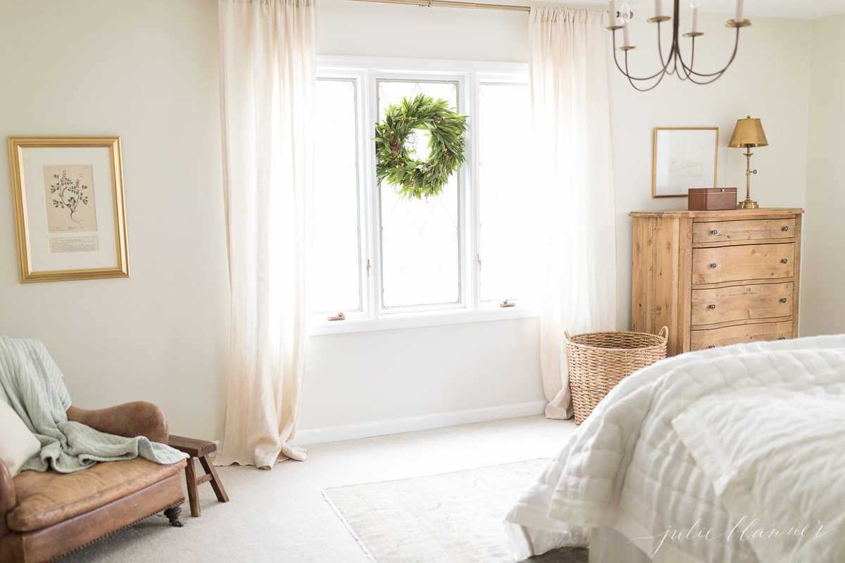 A white bedroom with a large basket for functional storage.