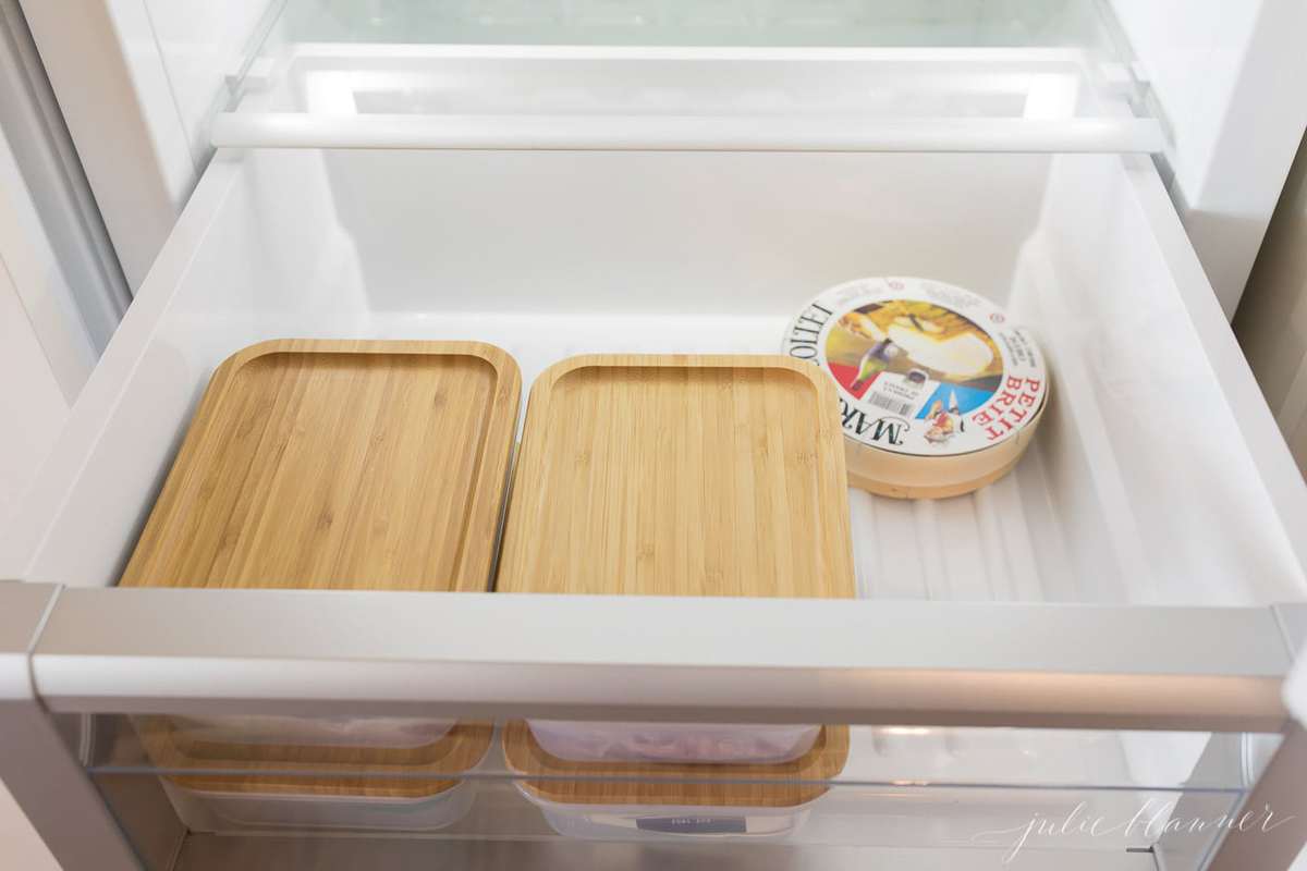 refrigerator storage inside an open organized refrigerator drawer.