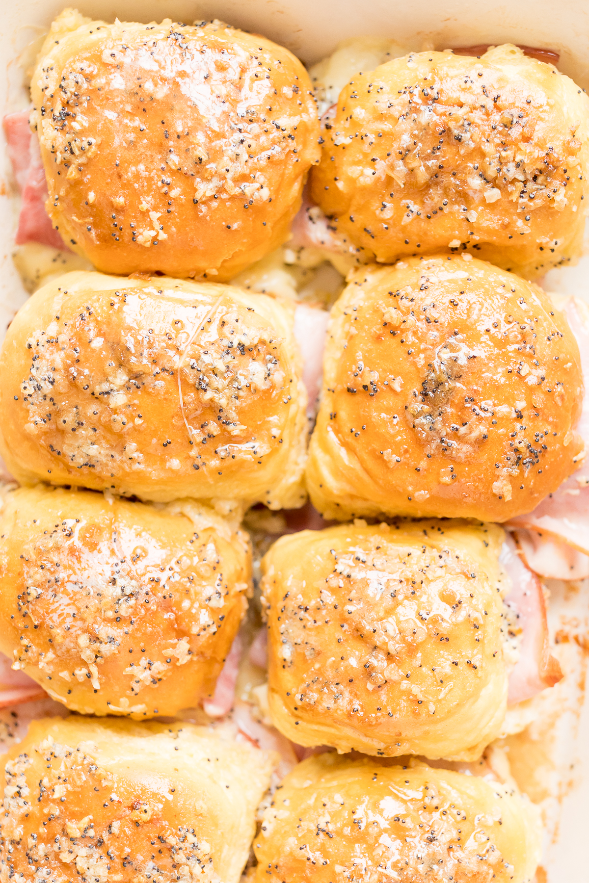 Delicious hot ham and cheese sliders baked to perfection in a dish.