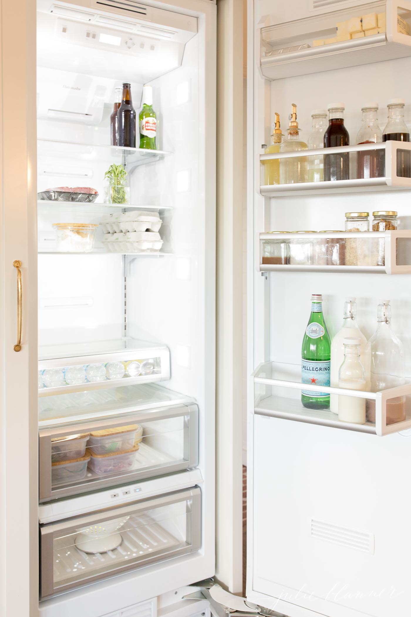fridge organization containers, clear glass jars in the door of a fridge.