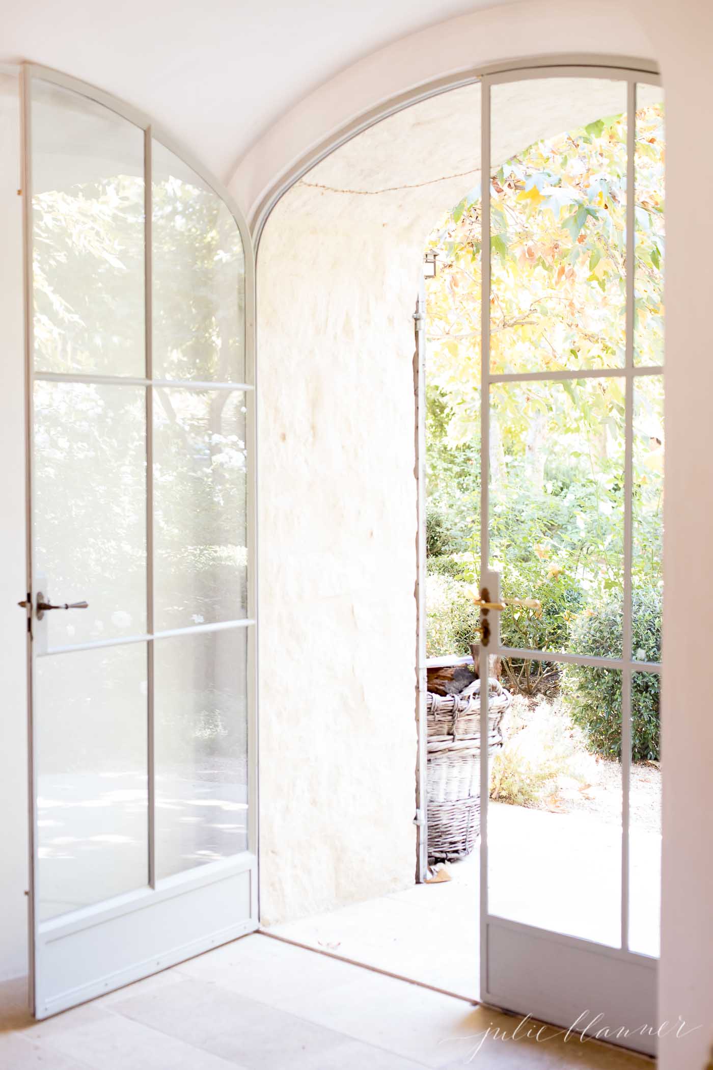 curved glass French doors heading to the outdoors in an exit space at Patina Farm, a California farmhouse