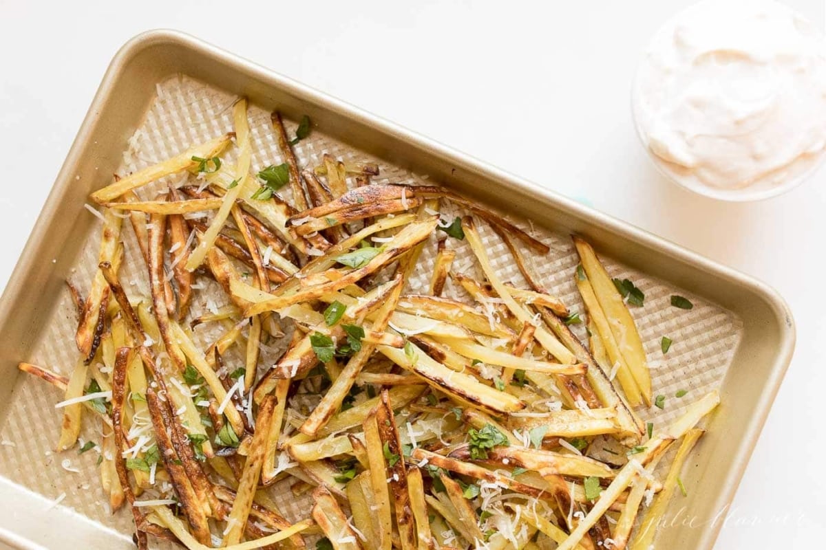 truffle fries with Parmesan and parsley on a sheet pan
