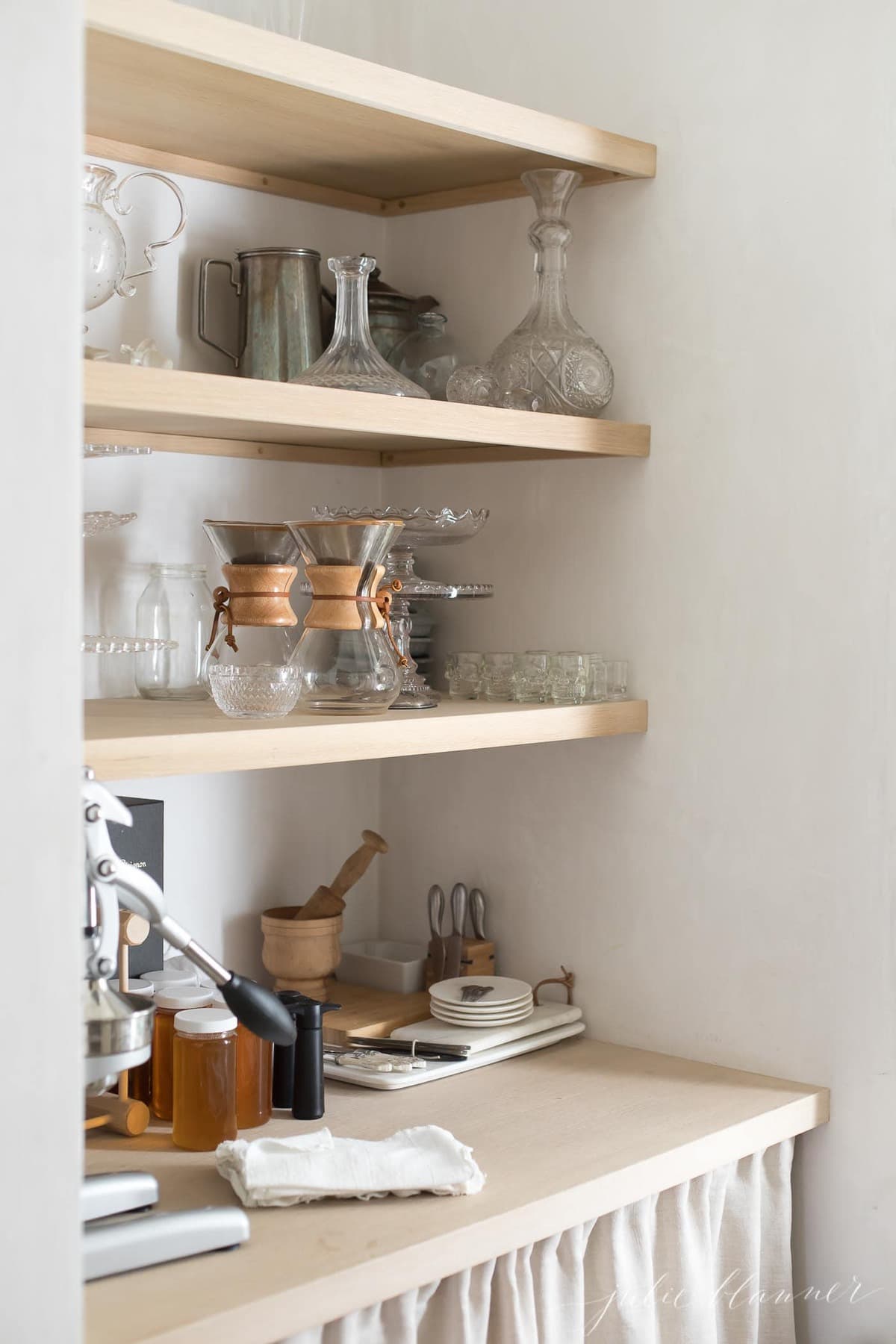 butlers pantry with a wooden countertop and a curtain to hide below