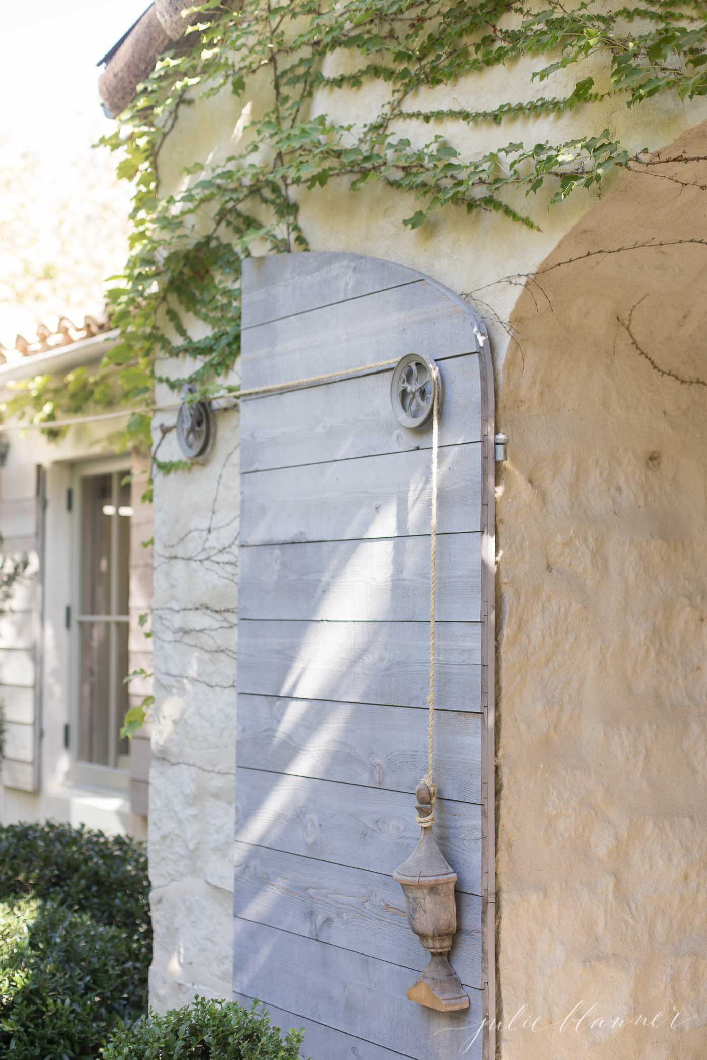 Patina Farm - a cottage with soft blue shutters and roses growing out front. 