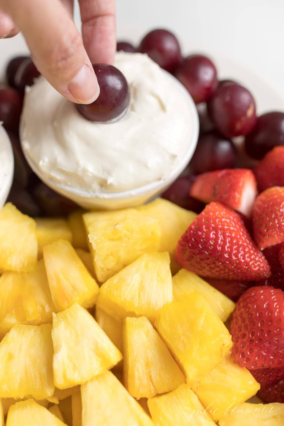 cream cheese fruit dip on a platter of fruit