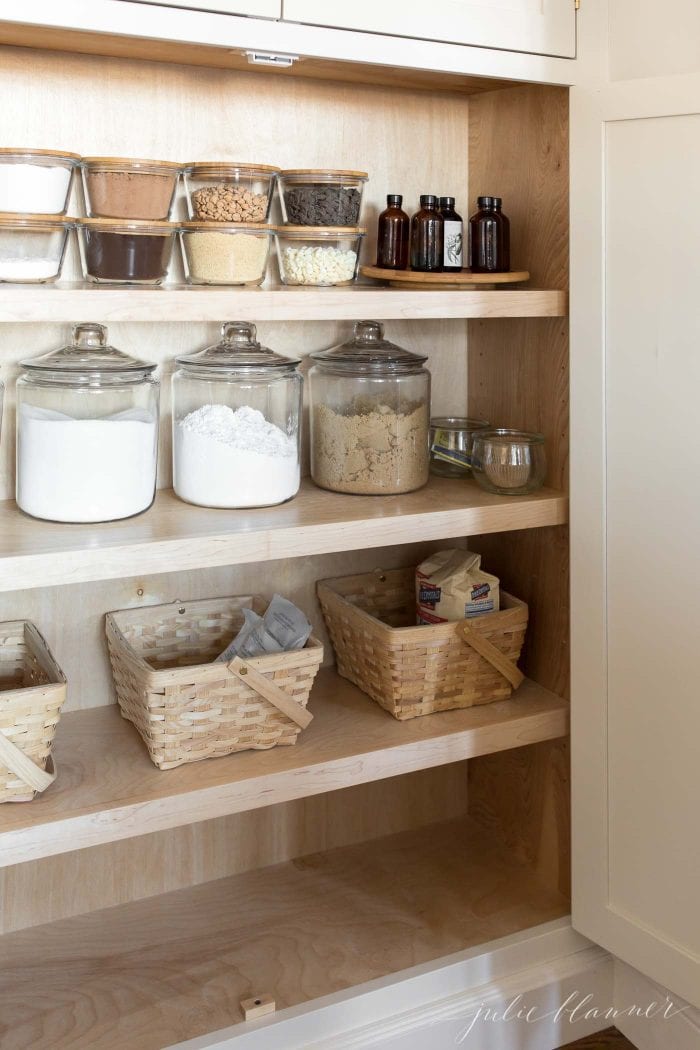 kitchen organization baking ingredients in pantry in glass jars and baskets