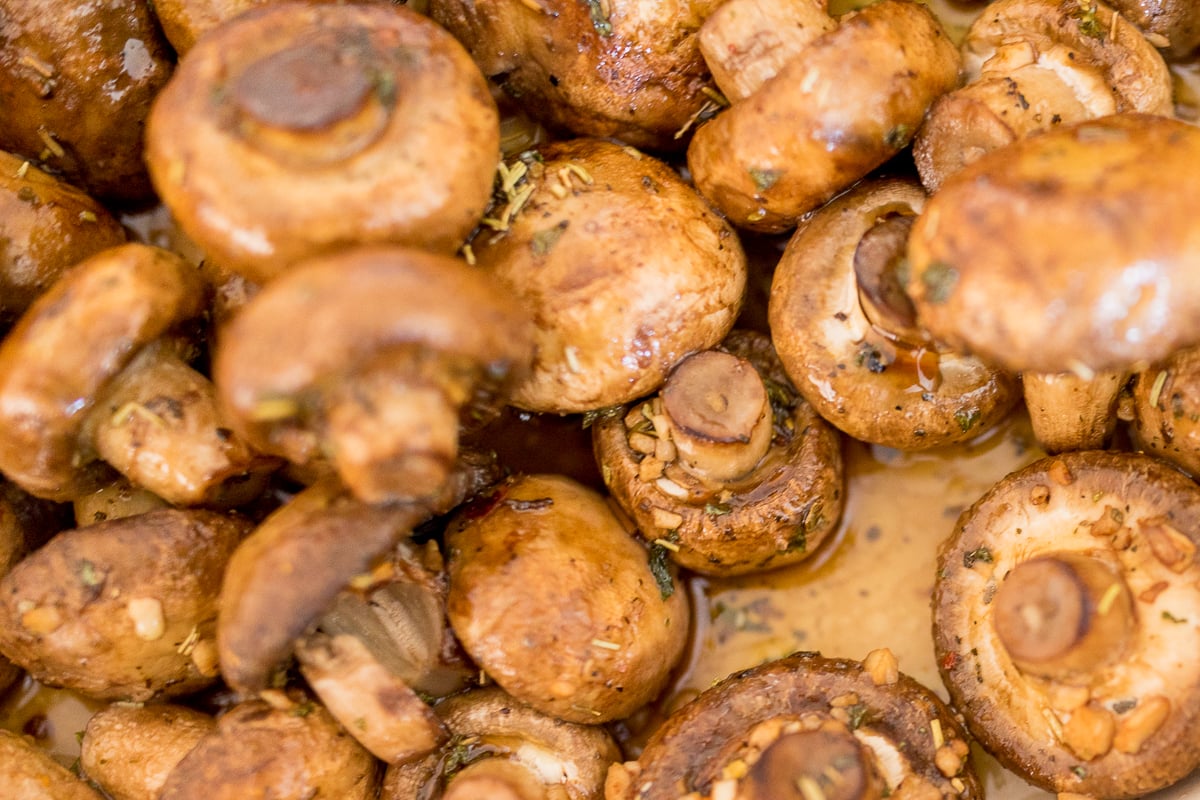 A close up of oven roasted mushrooms in a pan.