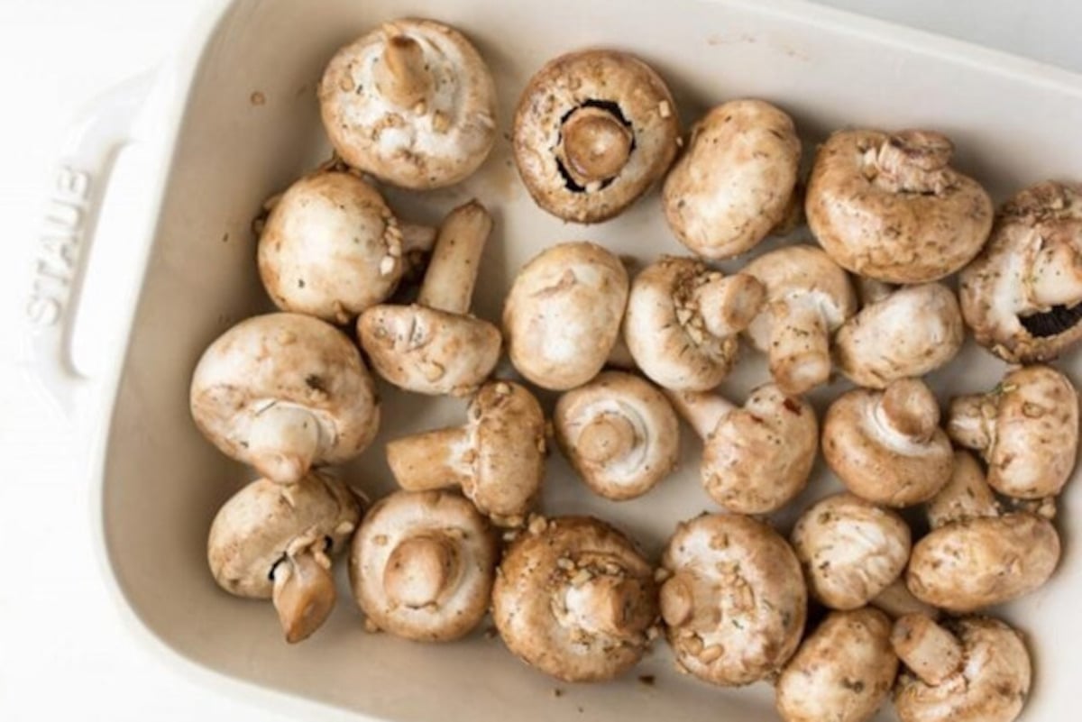 Oven Roasted Garlic Mushrooms served in a white baking dish.