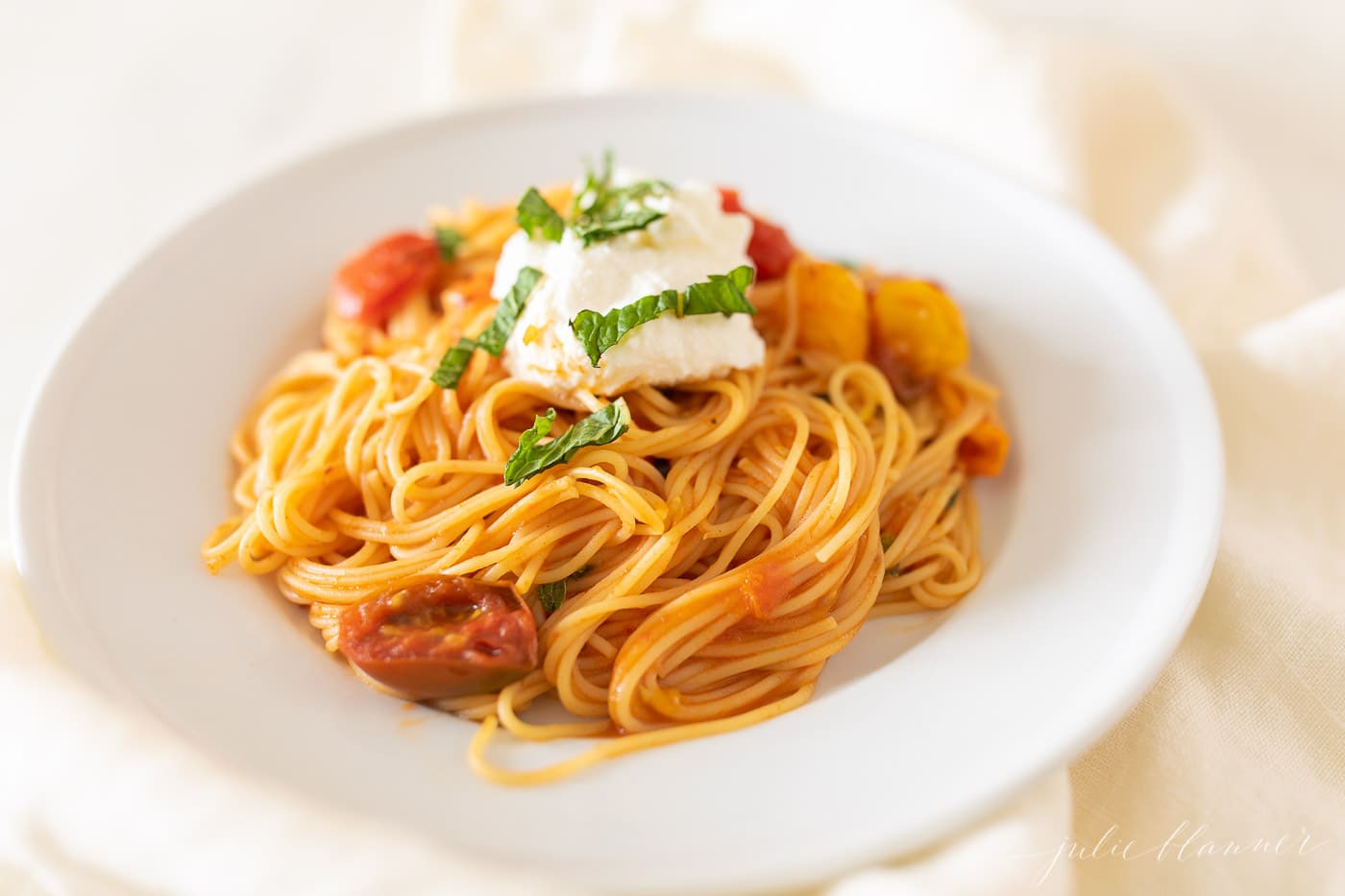Cherry Tomato pasta on a white plate. 