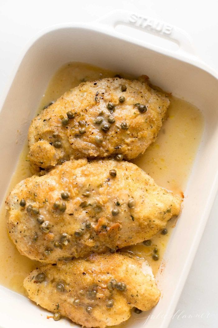 piccata milanese in piccata sauce in a casserole dish