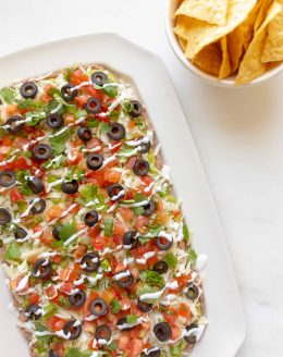 7 layer dip with refried beans, guacamole, pico de gallo, cilantro, green onions, olives and cheese.