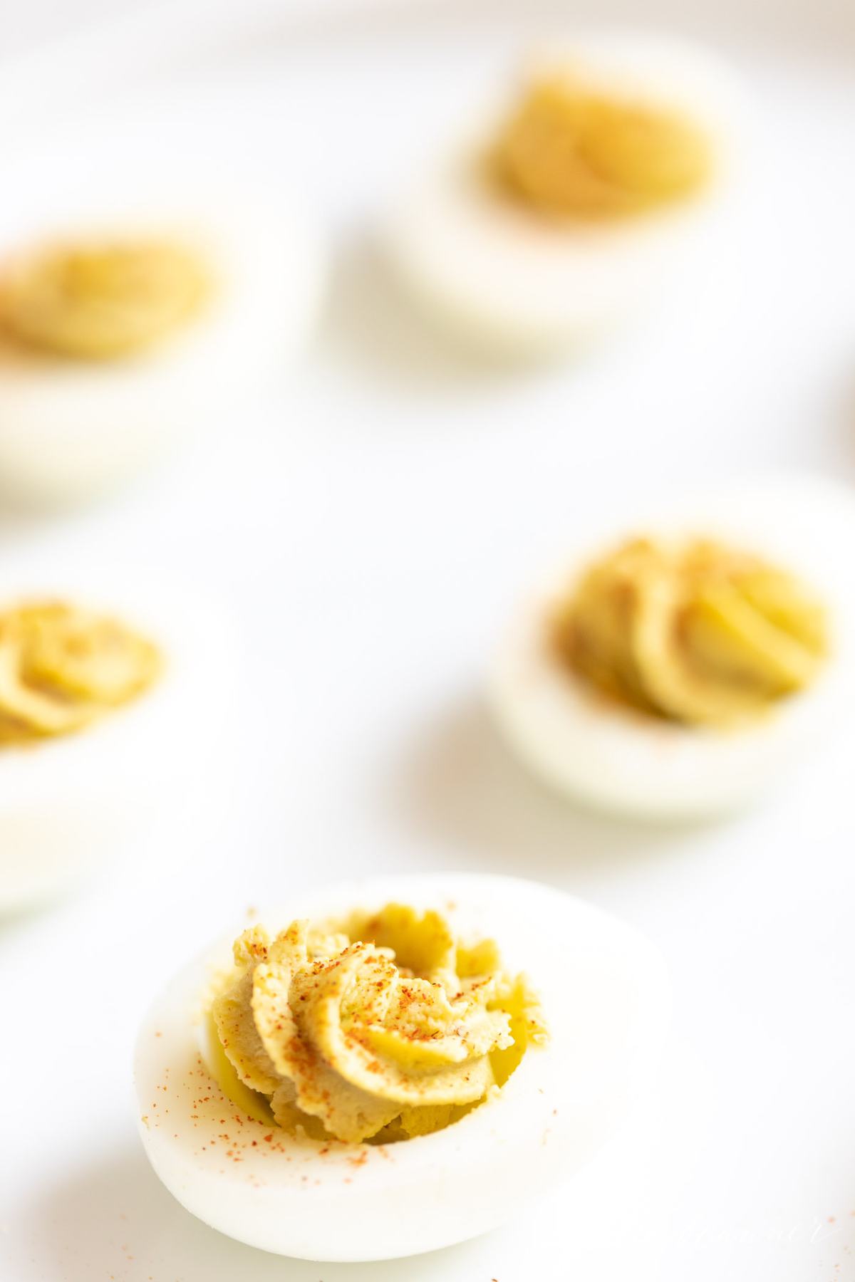avocado deviled eggs on a white surface. 