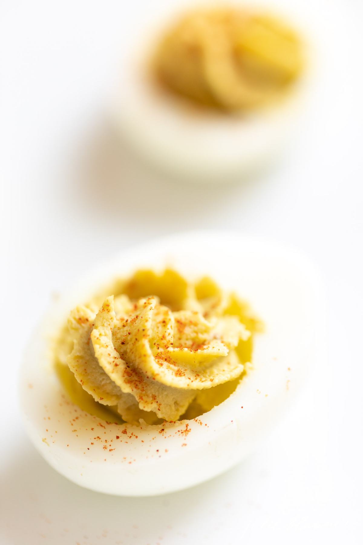 avocado deviled eggs on a white surface. 