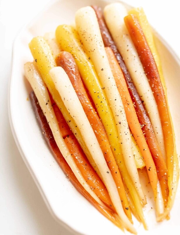 Candied carrots in a white dish.