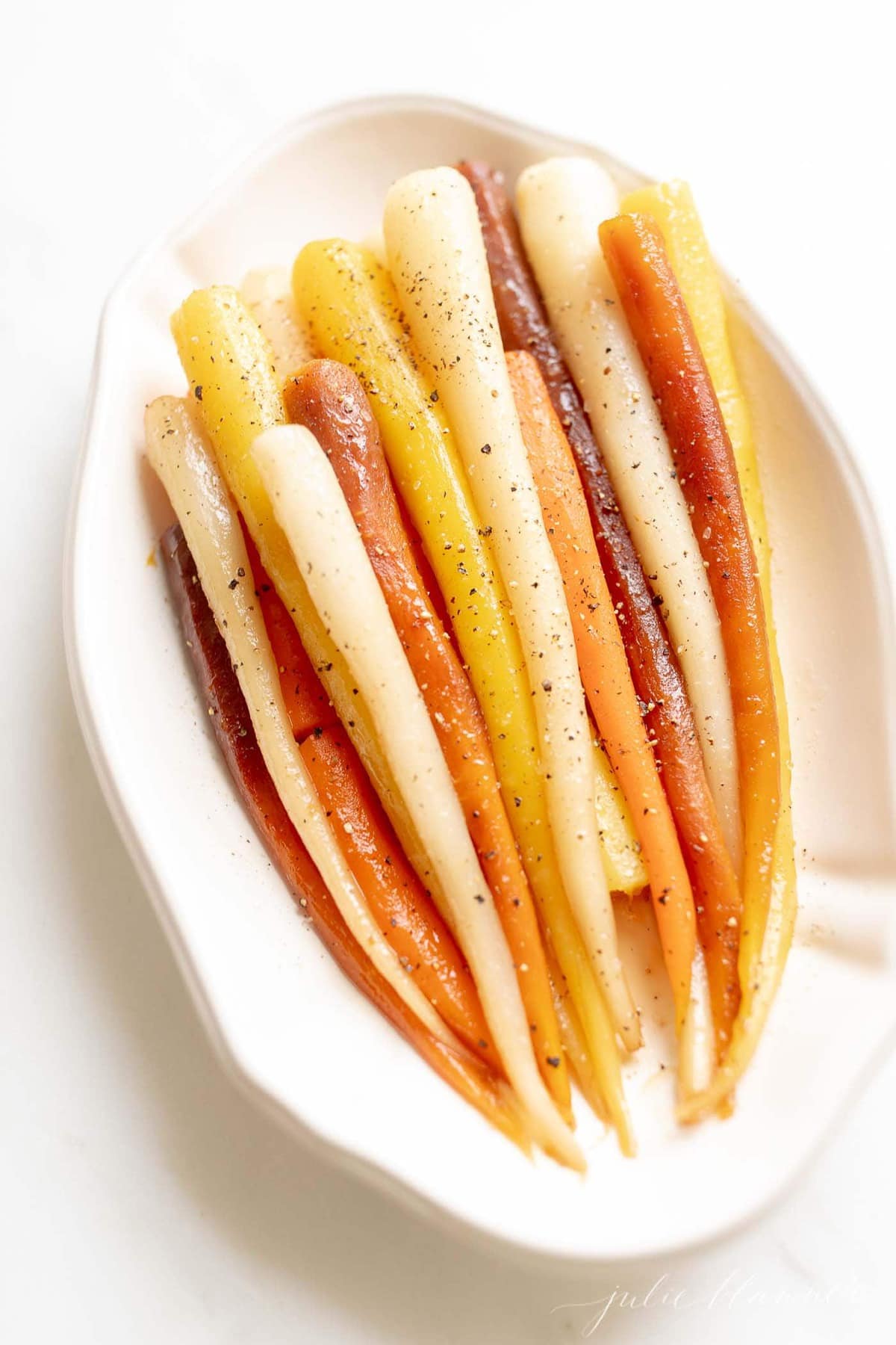 heirloom candied carrots lined in a dish