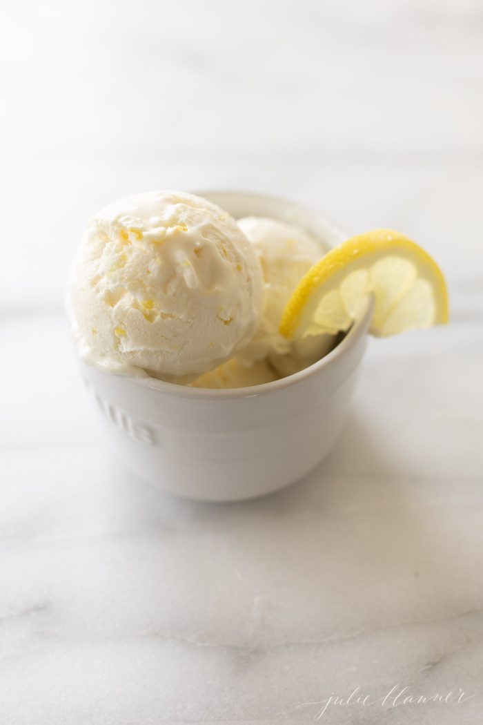no churn lemon ice cream in a white bowl on a marble surface