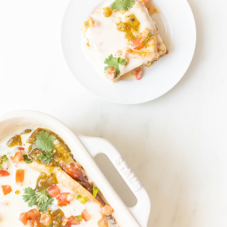 slice of mexican breakfast casserole on a plate next to casserole dish