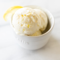 A white bowl full of homemade no churn lemon ice cream with condensed milk.