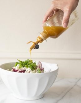 Bottle of Sherry Vinaigrette and salad