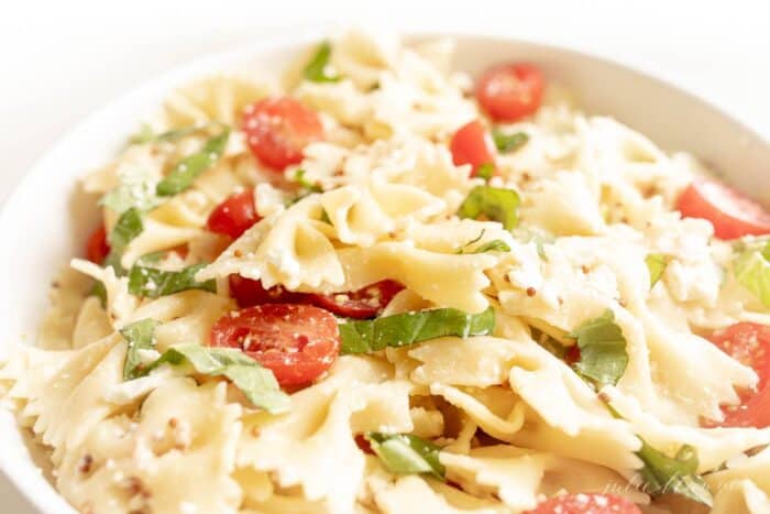 A bow tie pasta salad tossed with basil, cherry tomatoes and a light pasta salad dressing.