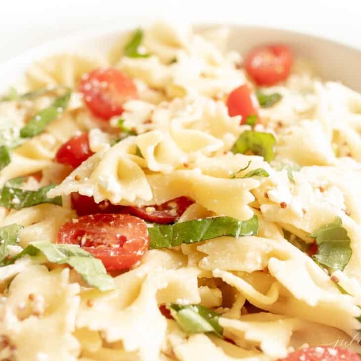 A bow tie pasta salad tossed with basil, cherry tomatoes and a light pasta salad dressing.