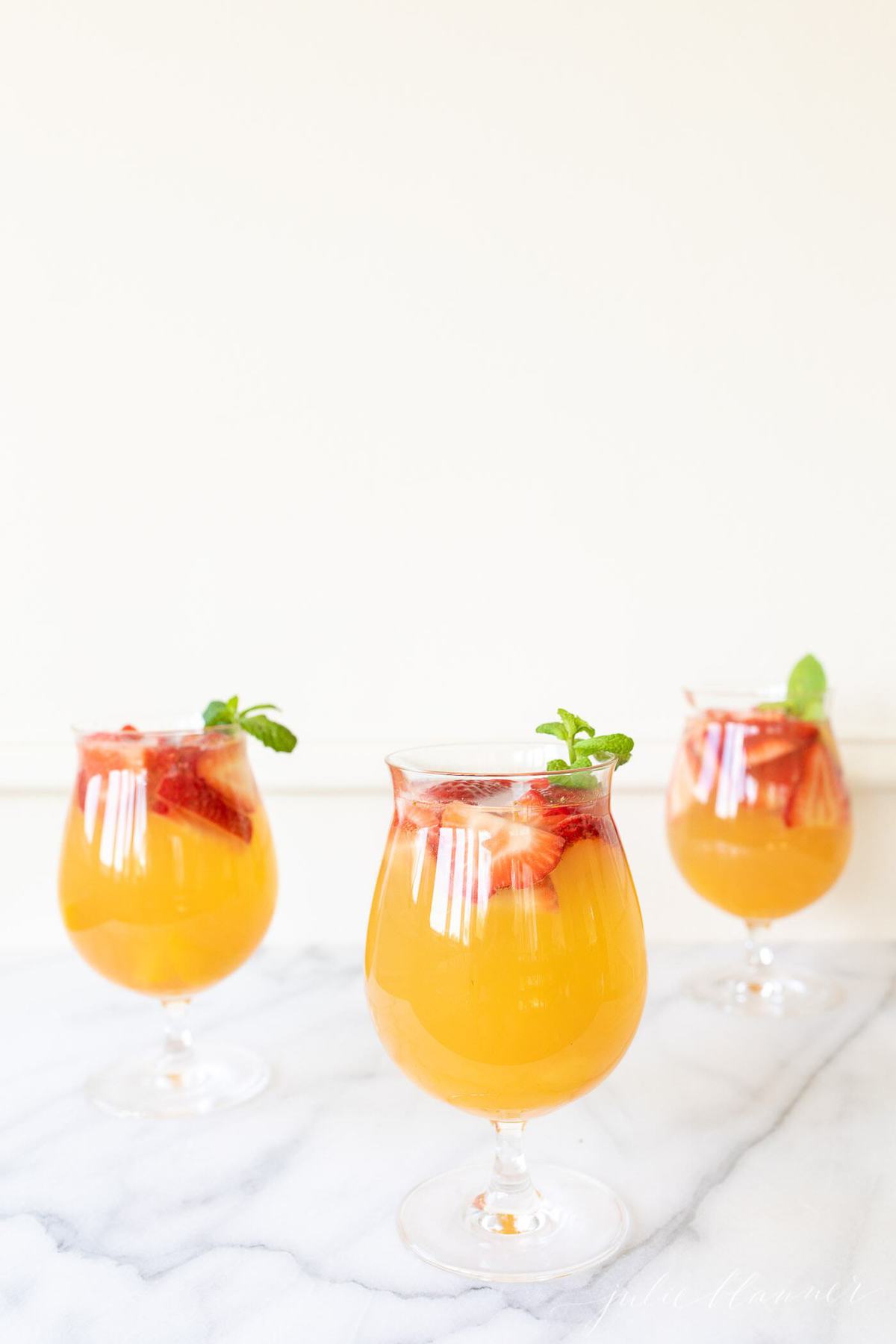 fruit sangria in clear glasses