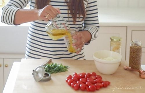 woman in stripe dress combing ingredients in jar