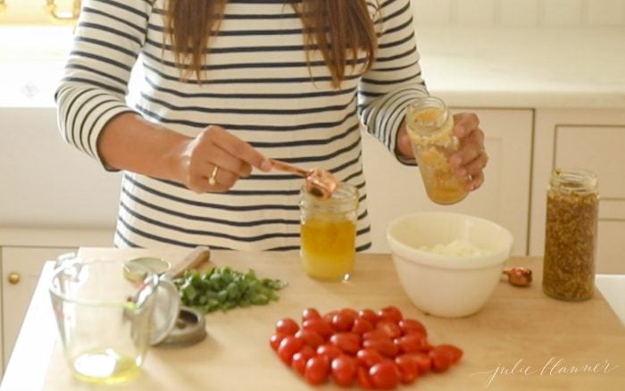puring ingredients in a jar to make pasta salad dressing