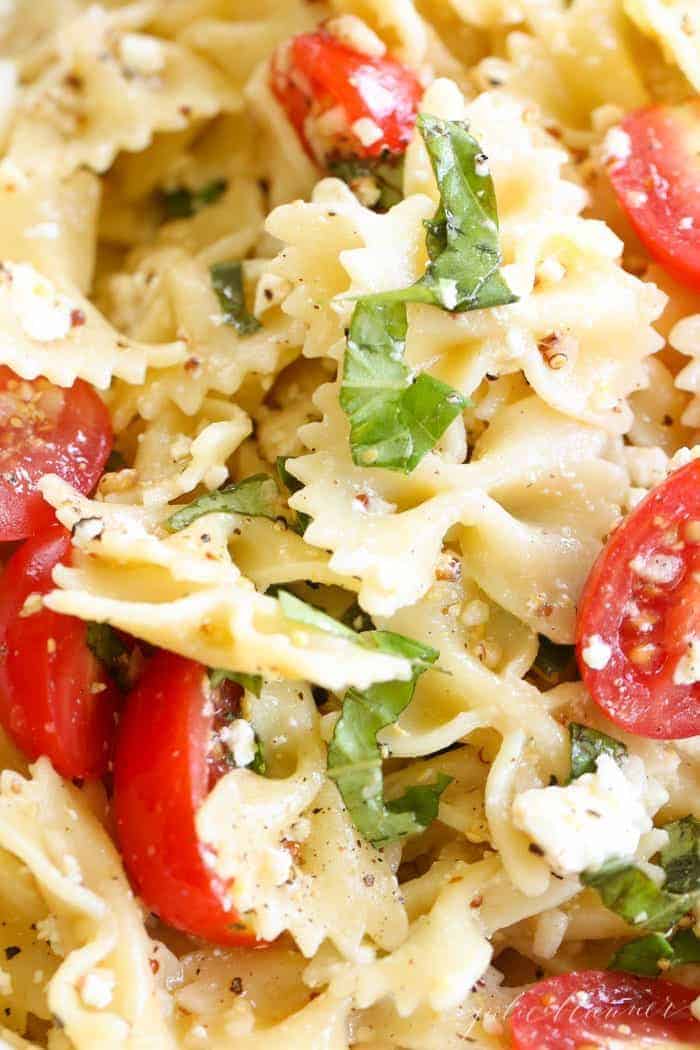 A bow tie pasta salad tossed with basil, cherry tomatoes and a light pasta salad dressing.