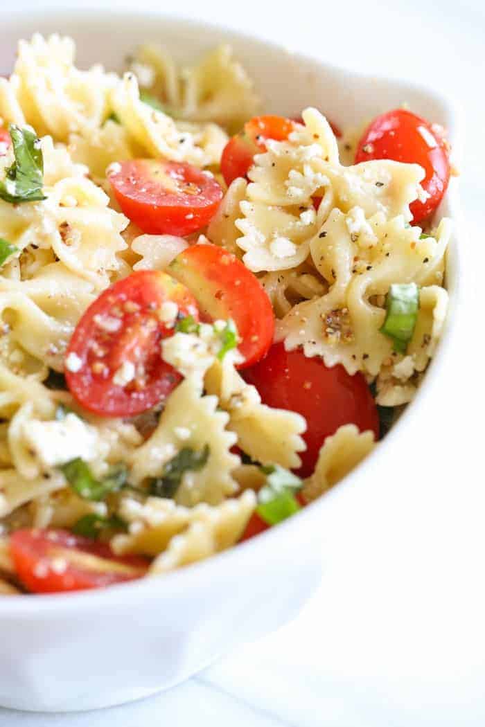 A bow tie pasta salad tossed with basil, cherry tomatoes and a light pasta salad dressing.