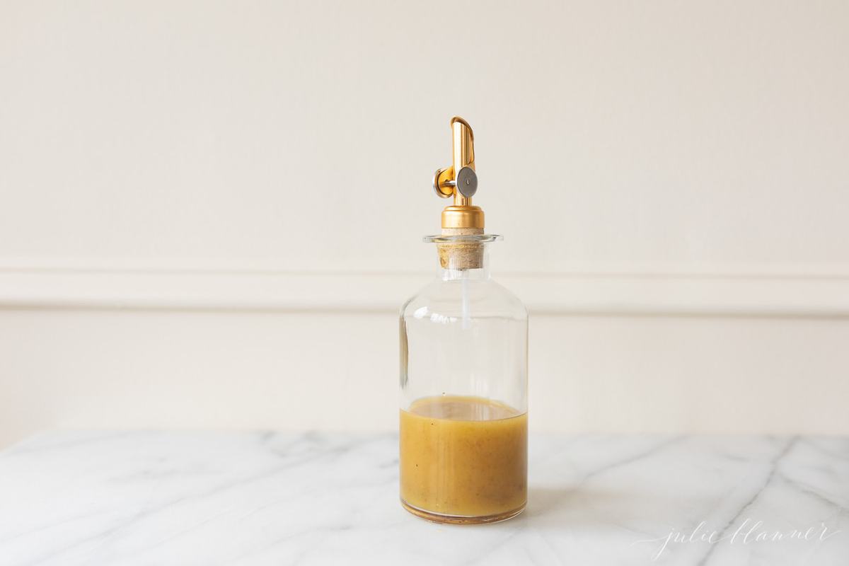 pasta salad dressing in glass jar with dispenser