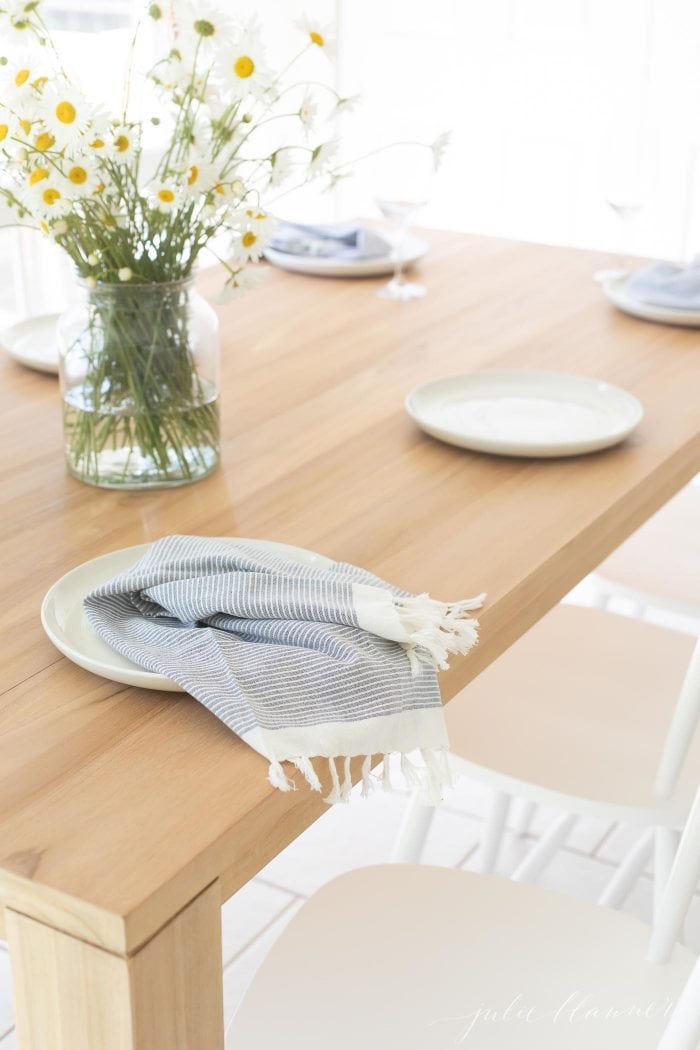 teak dining table with white chairs