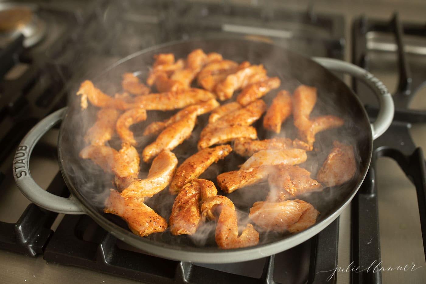 cajun spiced chicken on a cast iron skillet