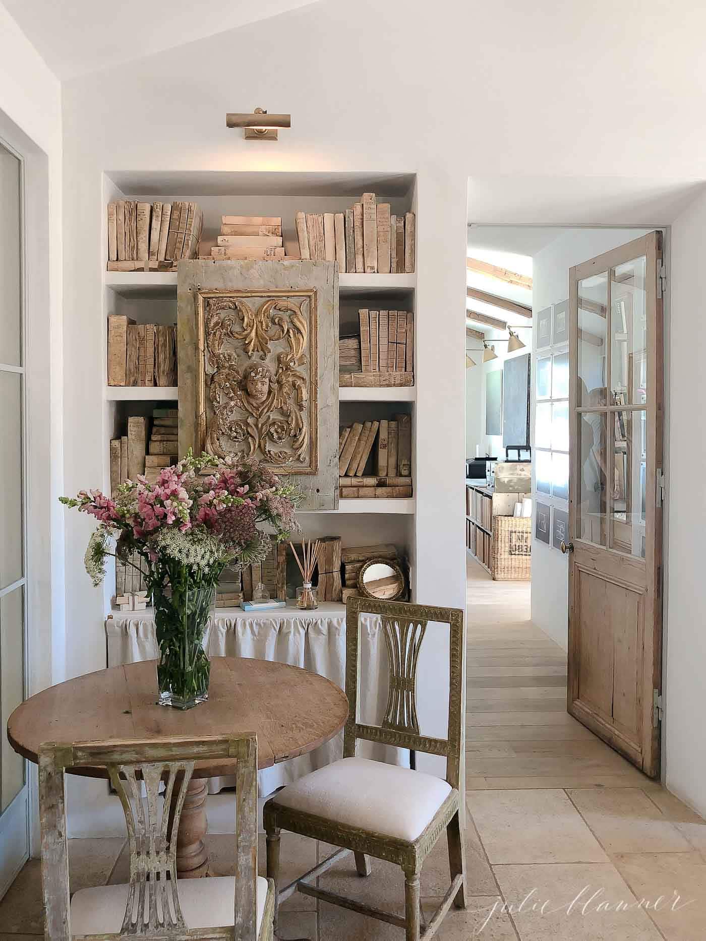 French country inspired library shelves filled with old books.