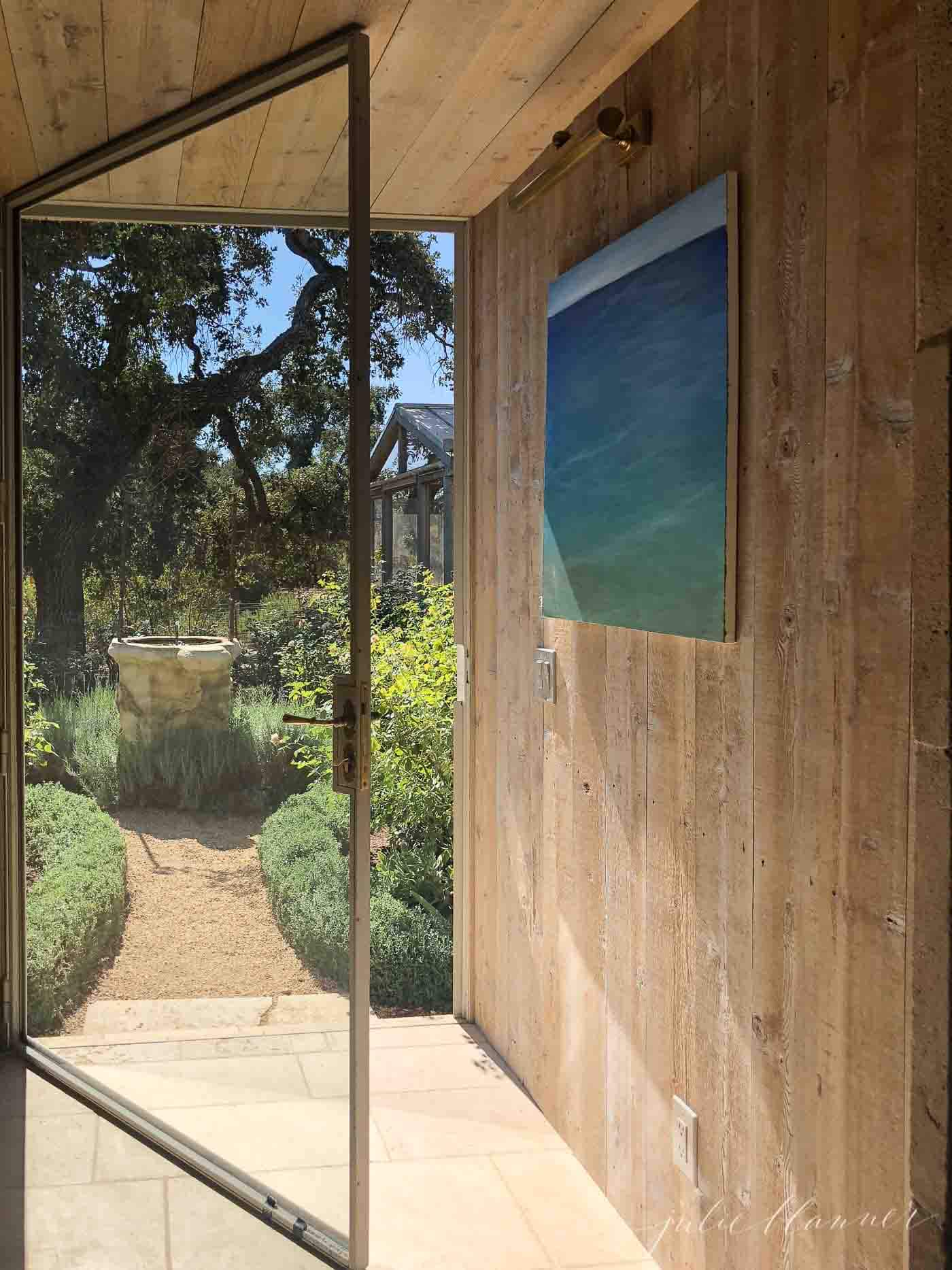 wood wall and large glass door in entryway