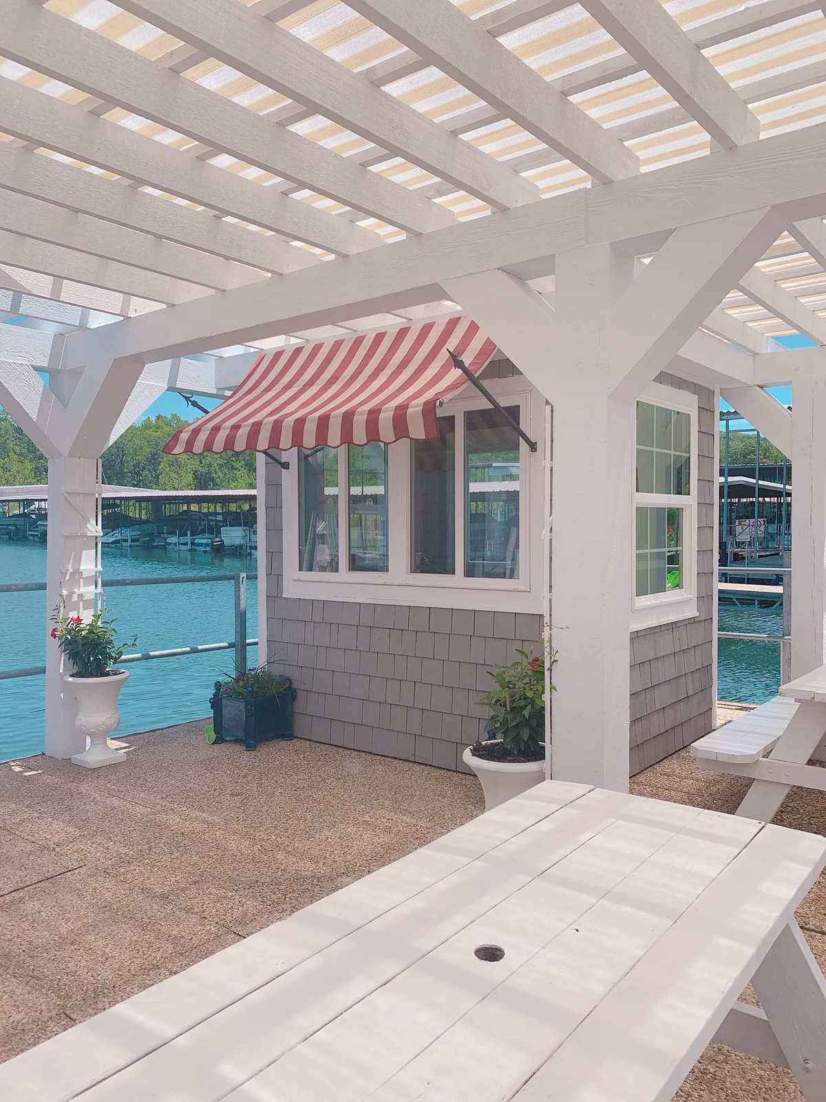 state park marina snow cone shop with stripe awning and pergola