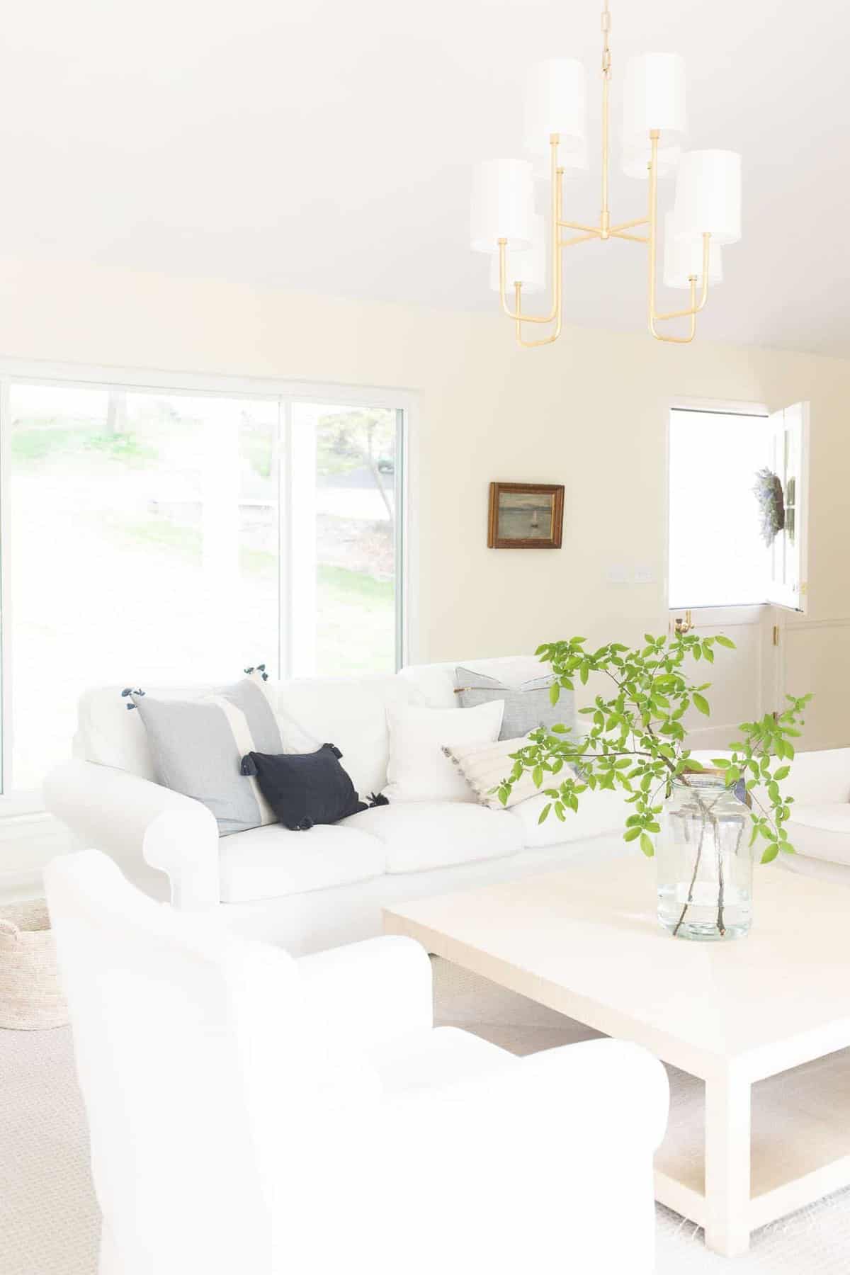 modern living room with cream walls, white ceiling and light colored furnishings.