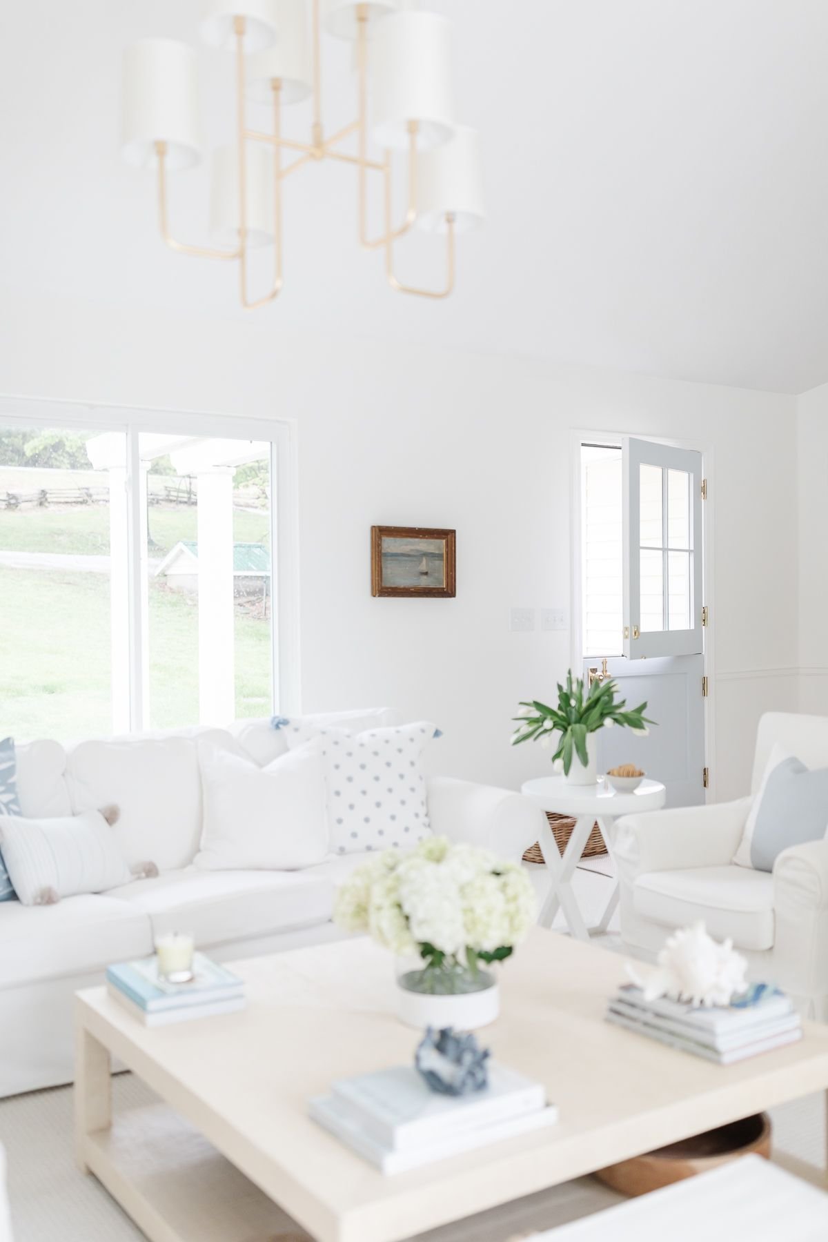 A white living room with white furniture and white ceiling paint.
