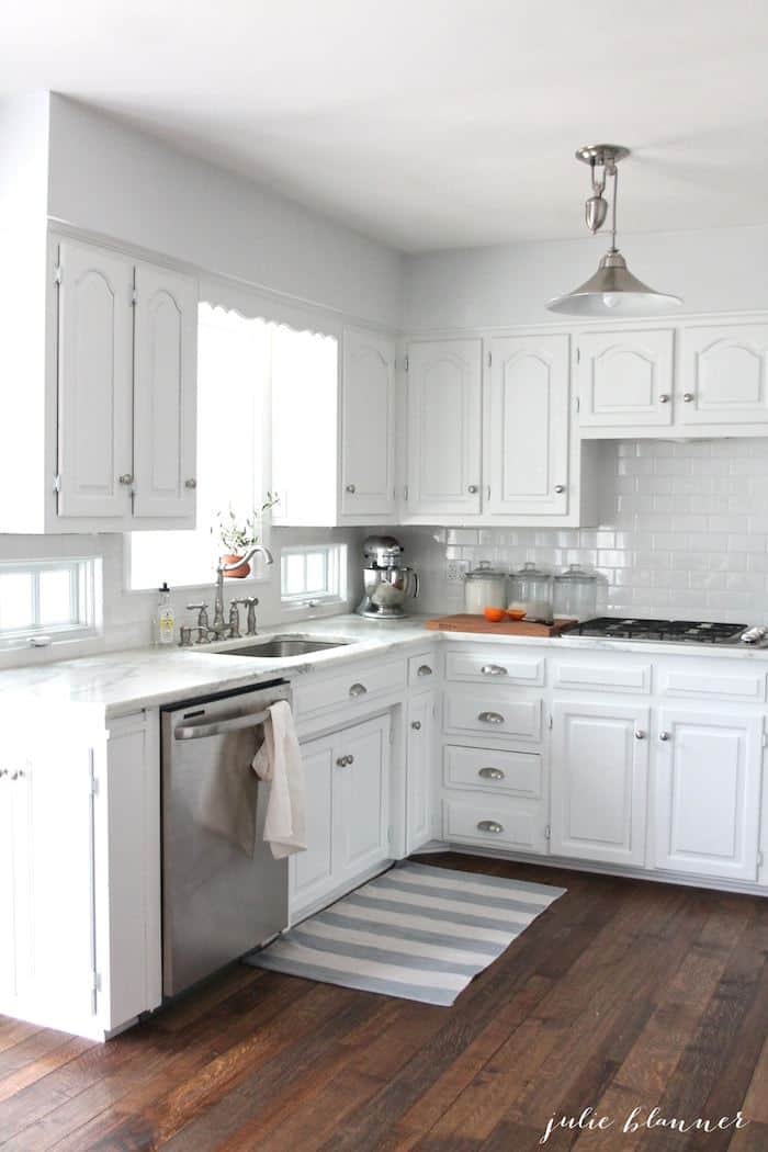 nickel pulley light in grey and white kitchen with wood floors