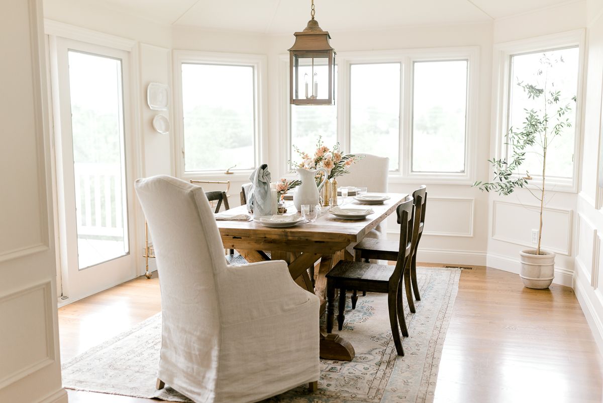 A farm table with a brass lantern hanging above