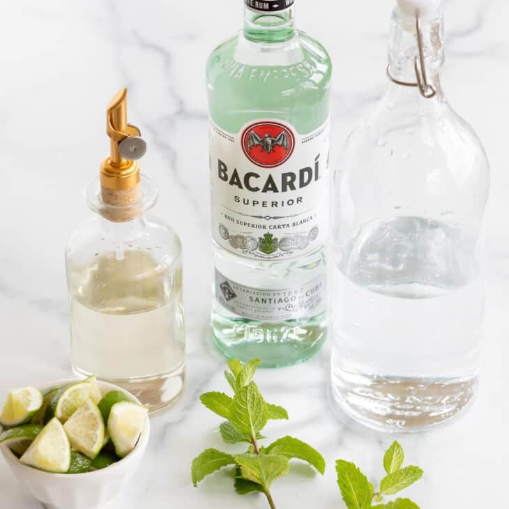 ingredients to make mojitos on marble surface