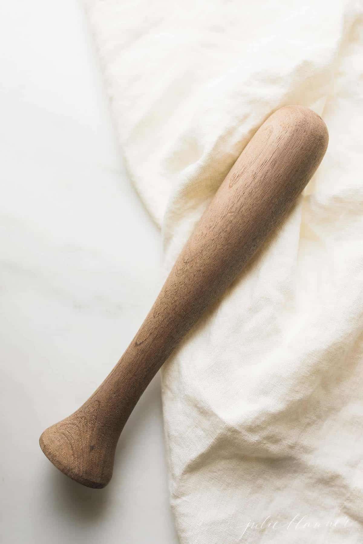 wood mojito muddler on a white surface