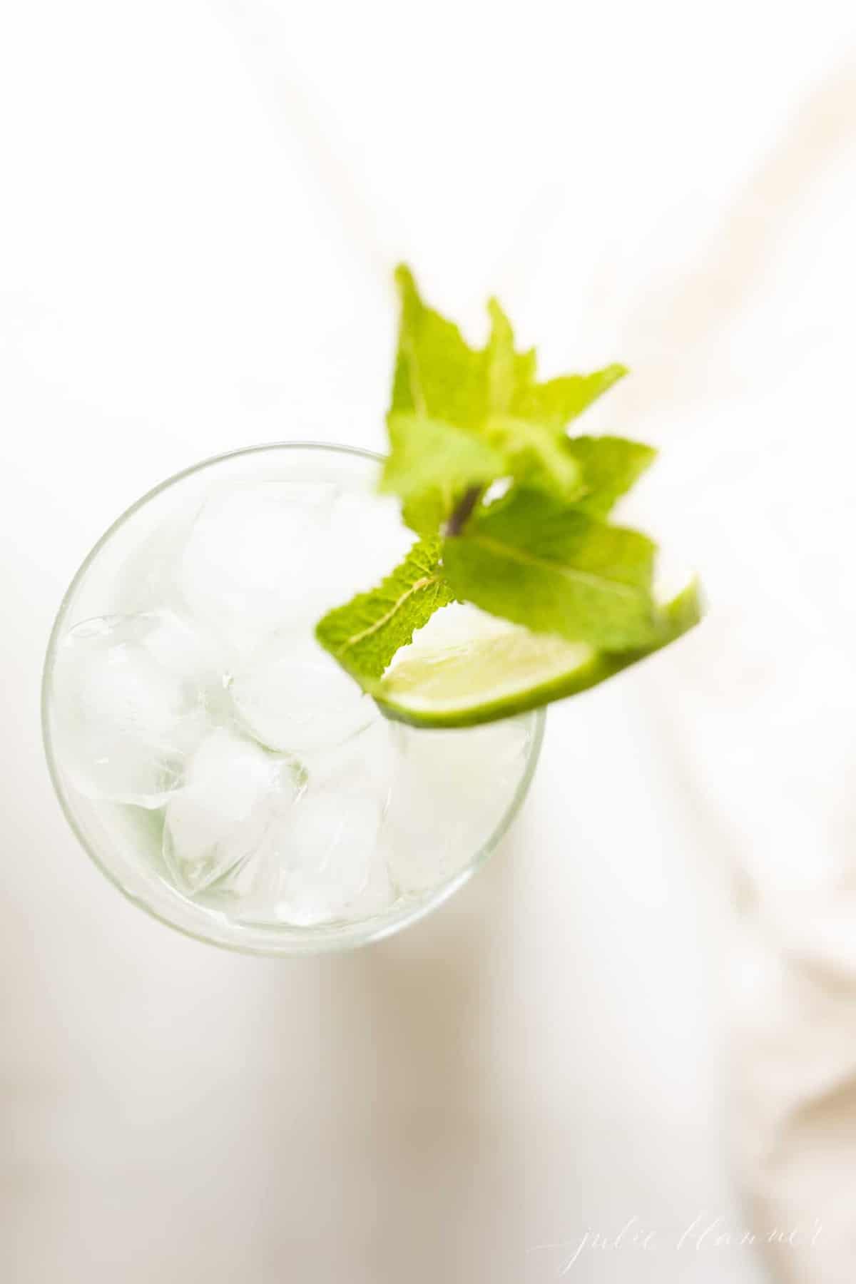 white marble countertop, looking down into an icy glass filled with a mojito.