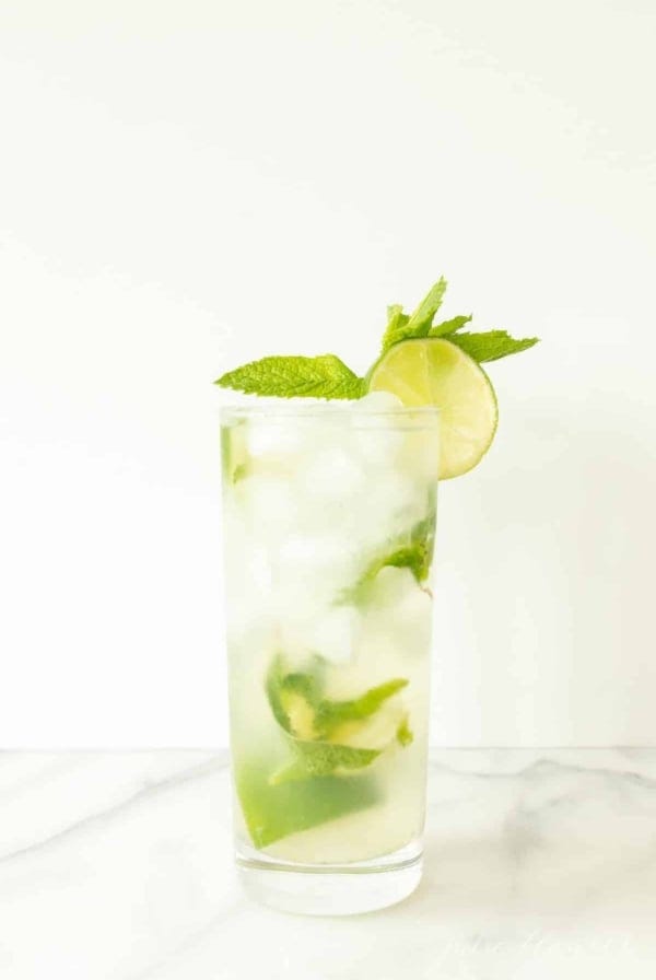 vodka mojito in highball garnished with mint sprig and lime